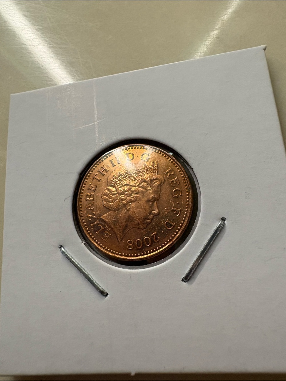 Copper-Colored Collector Coin in Protective Sleeve